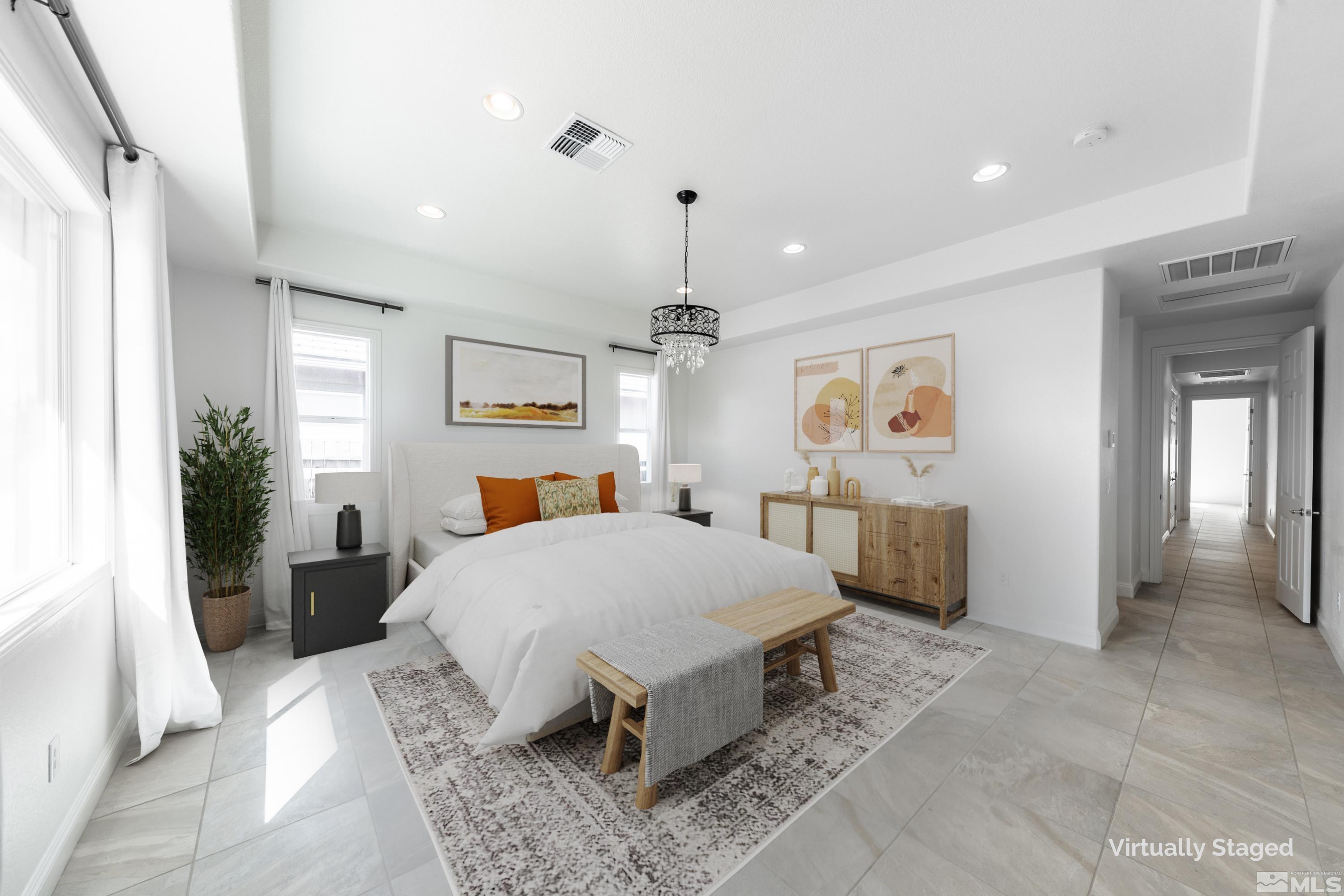 10065 Ellis Park Lane Reno, NV 89521 - Photo 17 of 30 a spacious bedroom with a large bed a potted plant and dresser