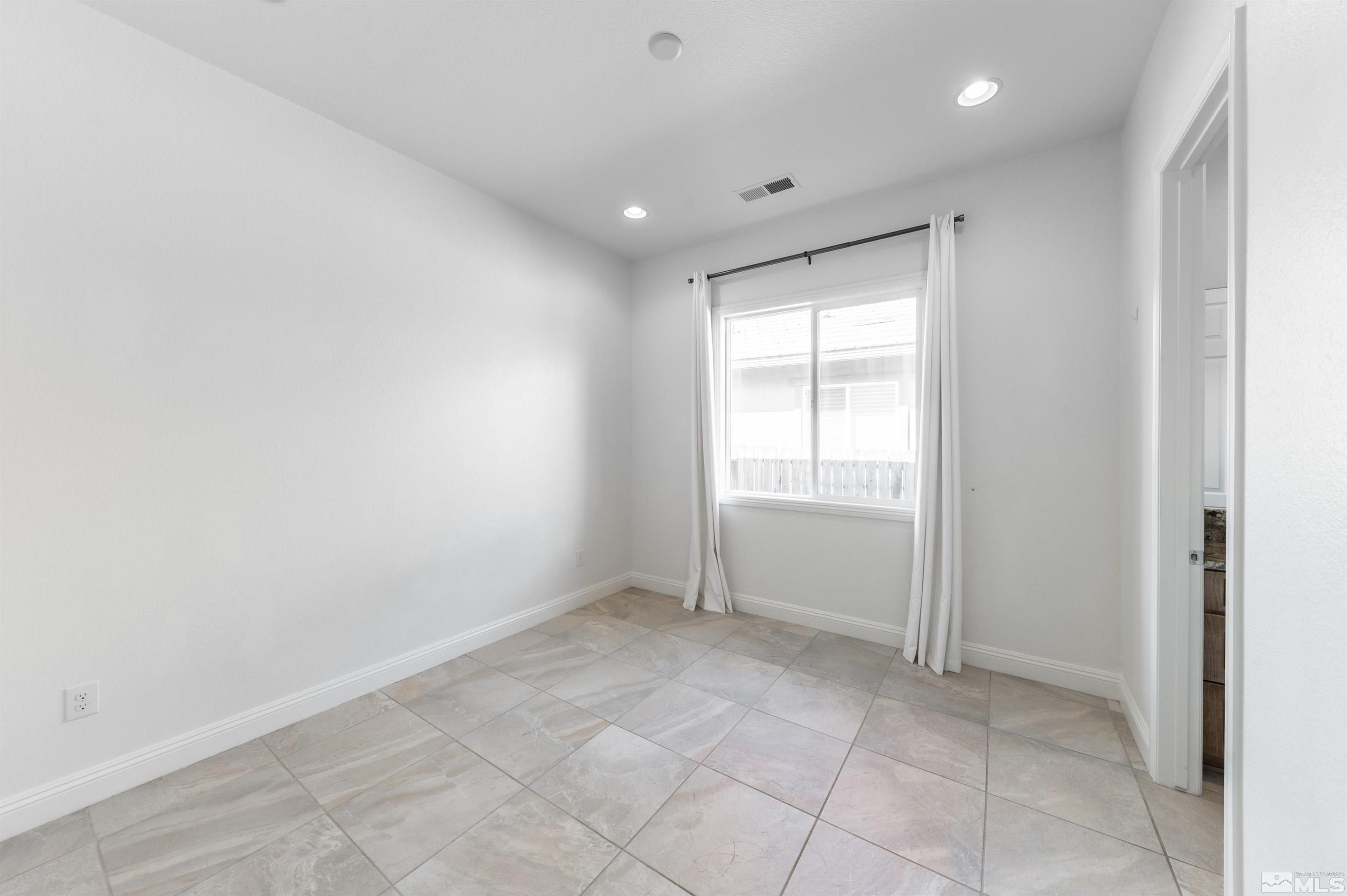 10065 Ellis Park Lane Reno, NV 89521 - Photo 21 of 30 a view of an empty room and a window