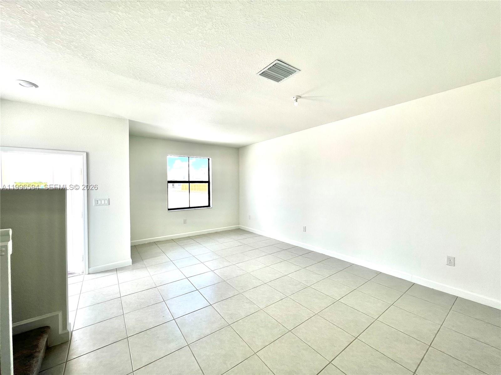 23373 Southwest 129th Path, Unit 23373 Homestead, FL 33032 - Photo 5 of 18 a view of an empty room