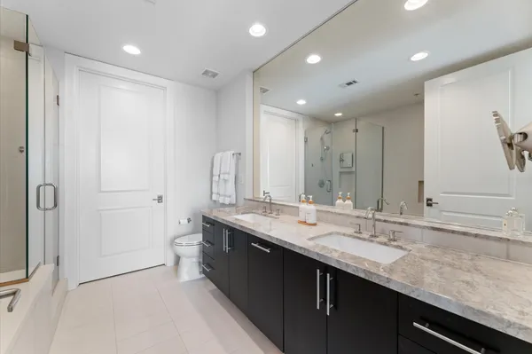 a bathroom with a double vanity sink mirror and double