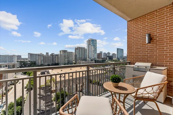 a balcony with table and chairs