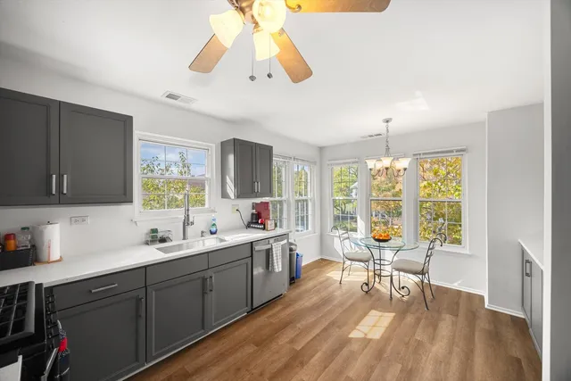 a kitchen with a table chairs sink and cabinets