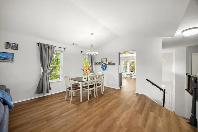 a view of a dining room with furniture and wooden floor