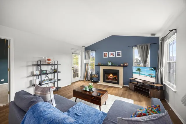 a living room with furniture a fireplace and a flat screen tv