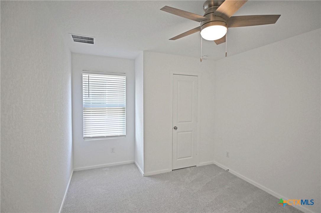 11560 Chestnut Rose St. Hedwig, TX 78152 - Photo 11 of 28 an empty room with a window and ceiling fan