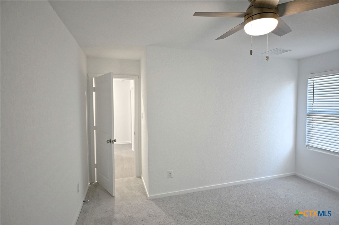 11560 Chestnut Rose St. Hedwig, TX 78152 - Photo 12 of 28 an empty room with a fan and a window