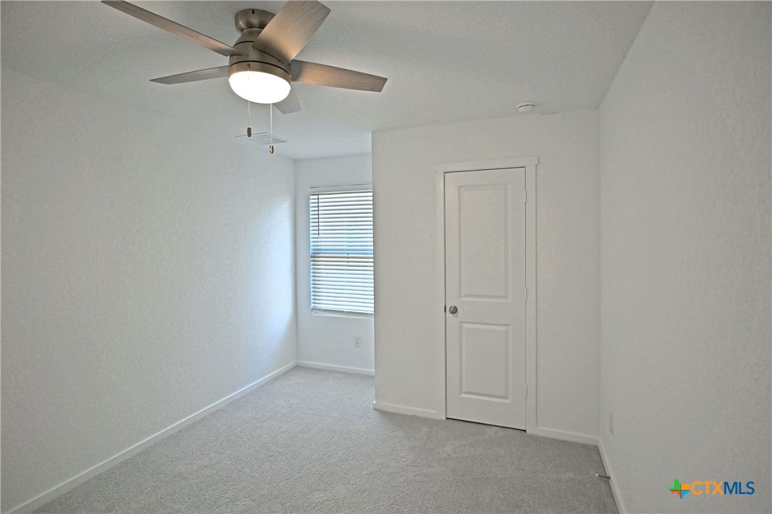 11560 Chestnut Rose St. Hedwig, TX 78152 - Photo 13 of 28 a view of an empty room and chandelier fan