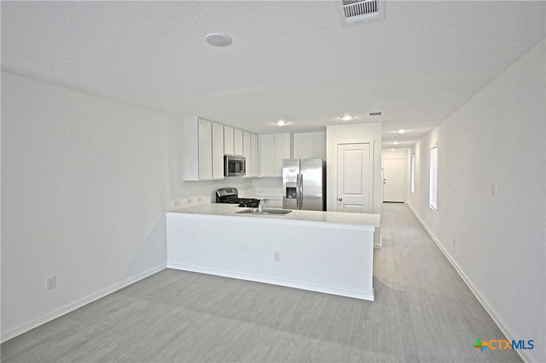 11560 Chestnut Rose St. Hedwig, TX 78152 - Photo 17 of 28 a view of kitchen with stainless steel appliances kitchen island sink and refrigerator