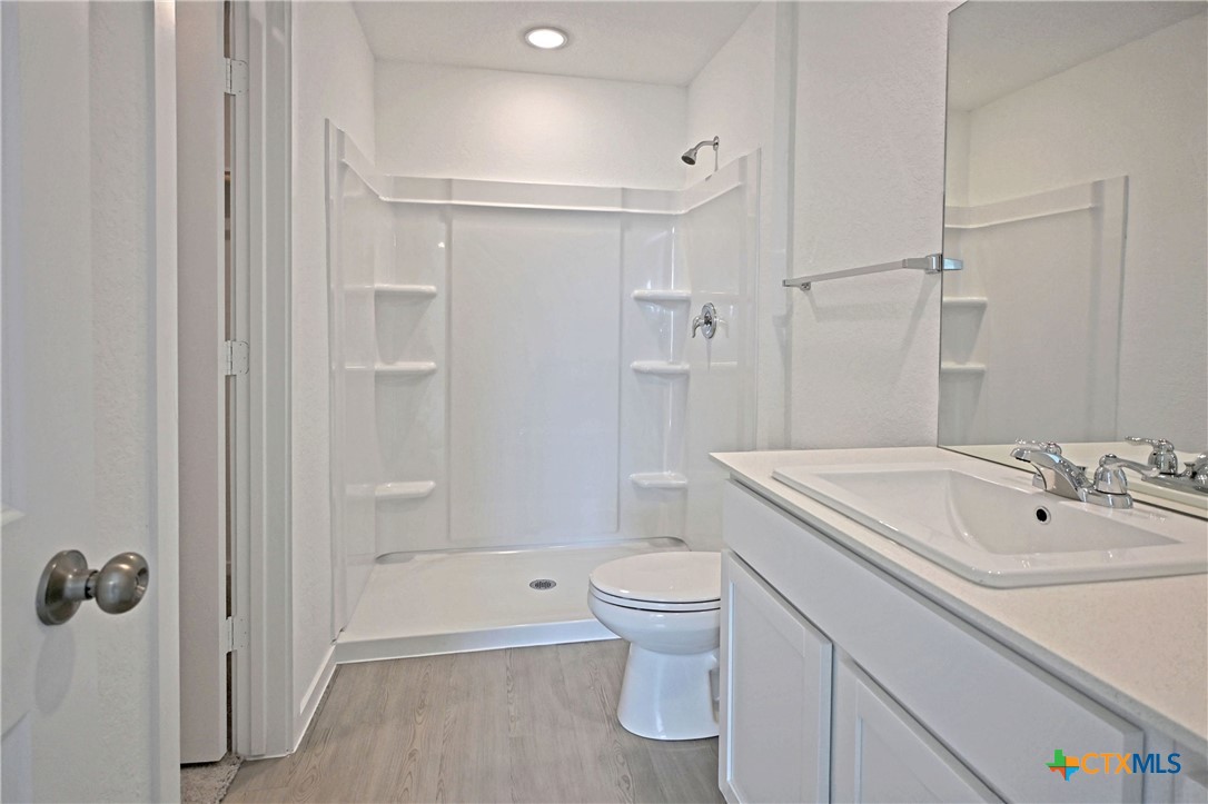 11560 Chestnut Rose St. Hedwig, TX 78152 - Photo 20 of 28 a bathroom with a sink a toilet and shower