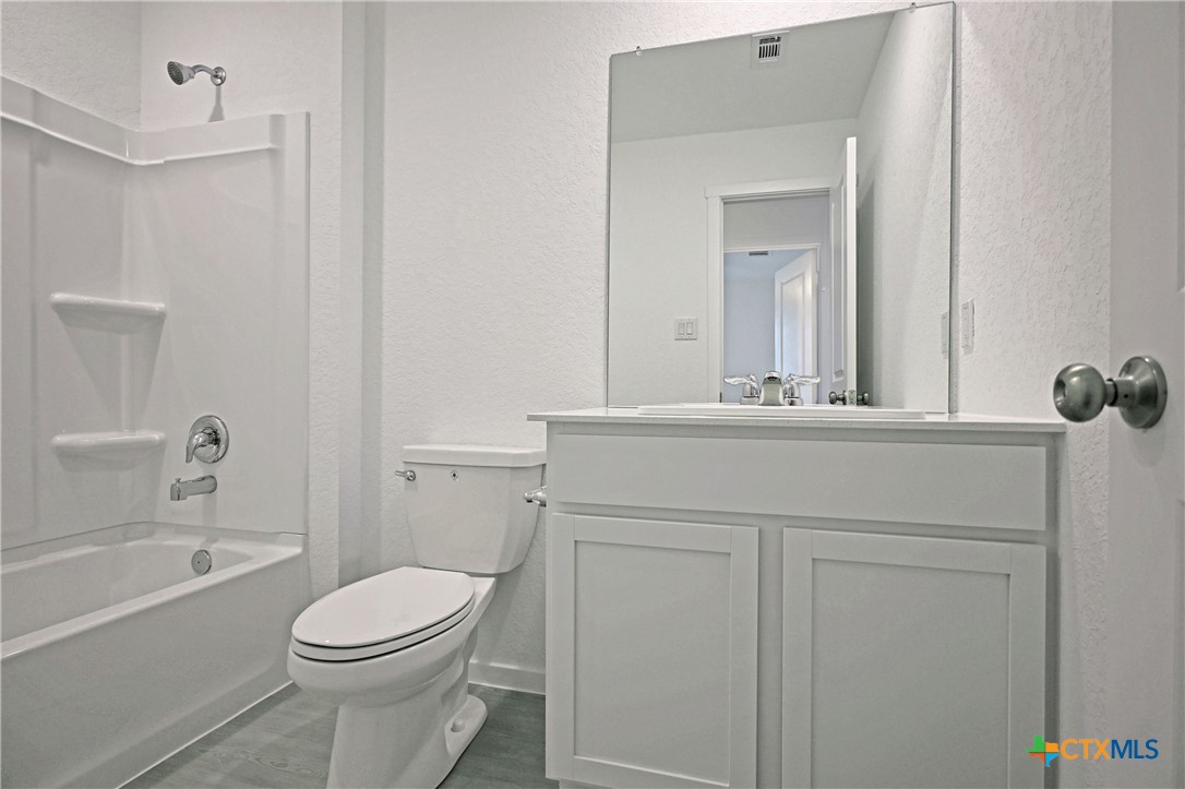 11560 Chestnut Rose St. Hedwig, TX 78152 - Photo 7 of 28 a bathroom with a sink a toilet and shower