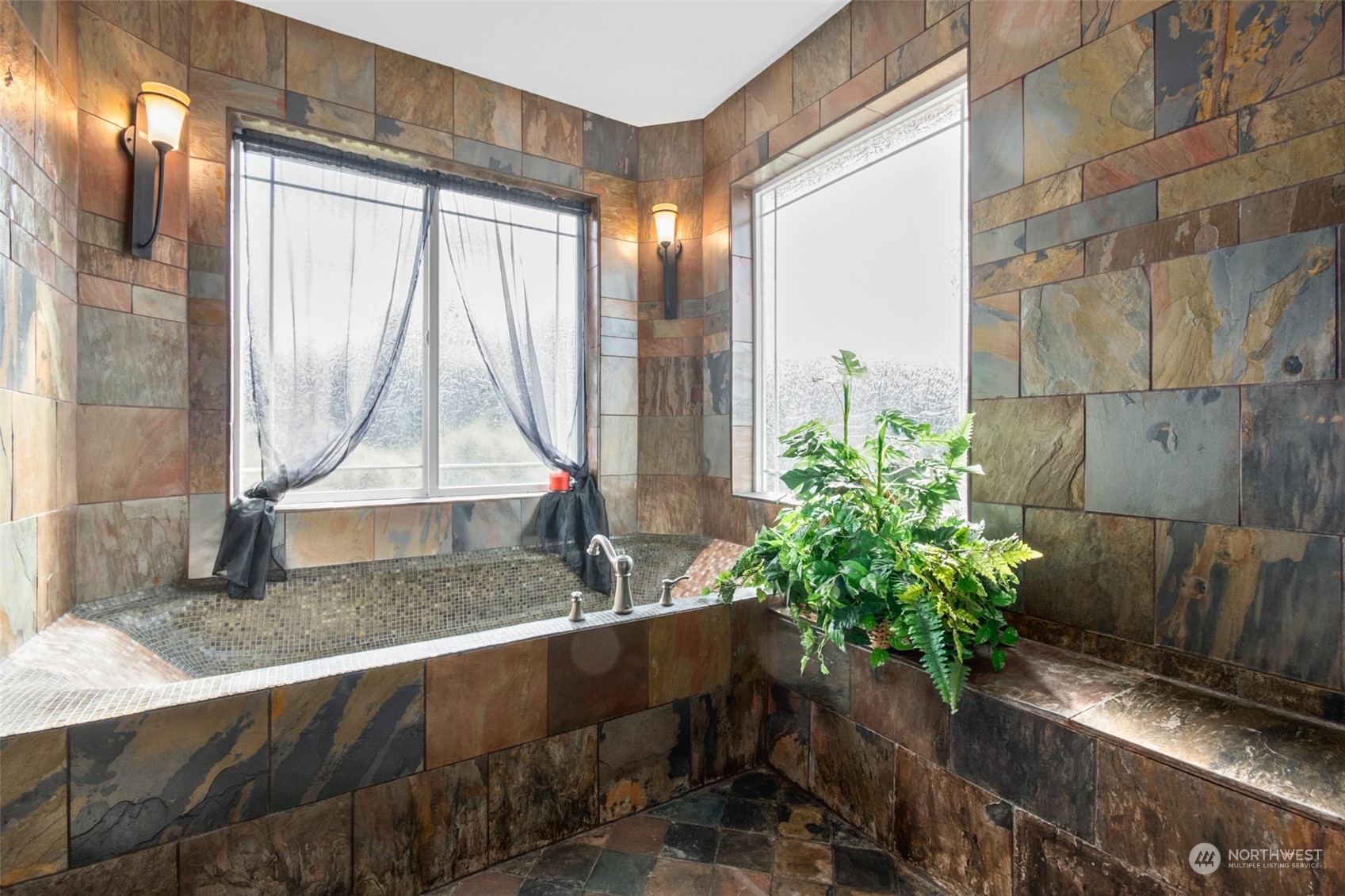 6504 263rd Street East Graham, WA 98338 - Photo 14 of 38 a living room with a couch and a potted plant