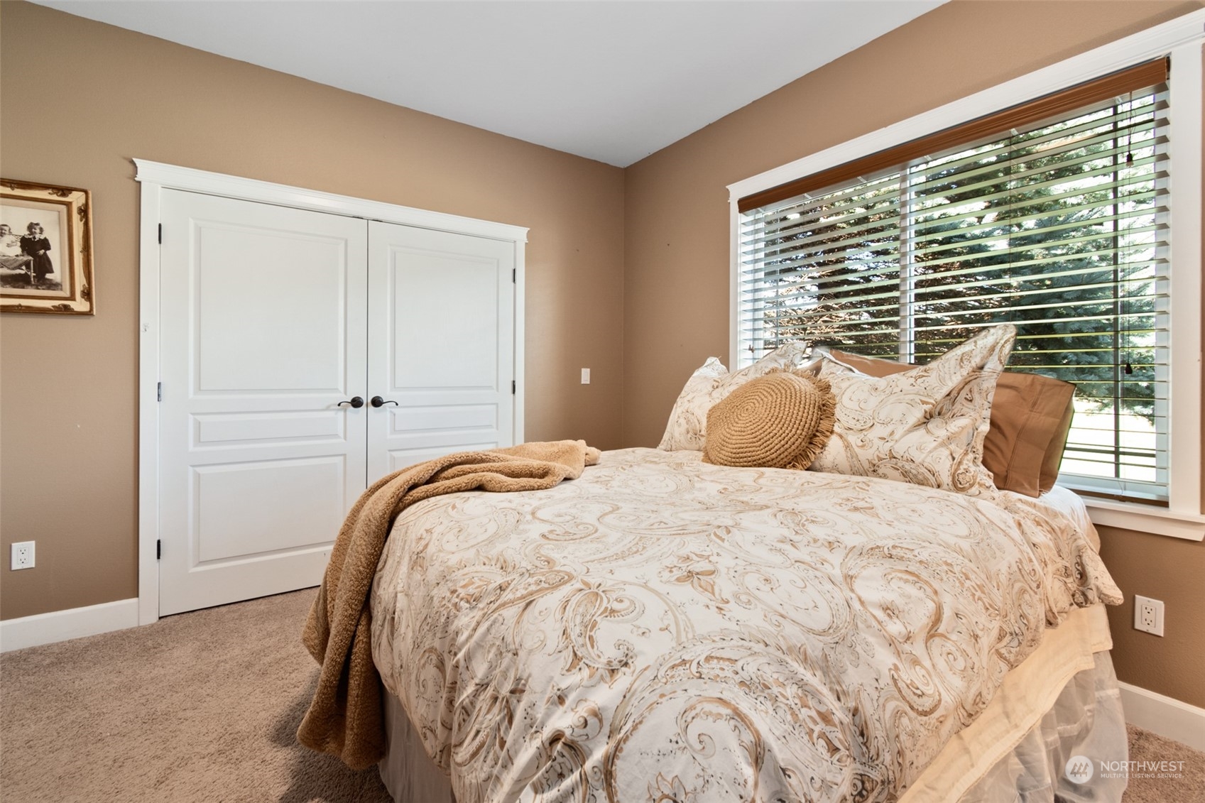 6504 263rd Street East Graham, WA 98338 - Photo 17 of 38 a large bed sitting in a bedroom next to a window