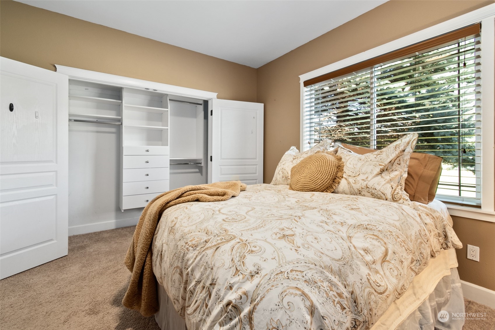 6504 263rd Street East Graham, WA 98338 - Photo 18 of 38 a bedroom with a bed and a large window