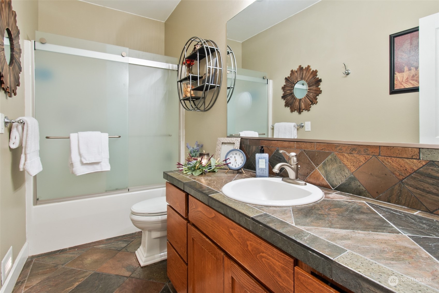 6504 263rd Street East Graham, WA 98338 - Photo 19 of 38 a bathroom with a granite countertop sink and a mirror