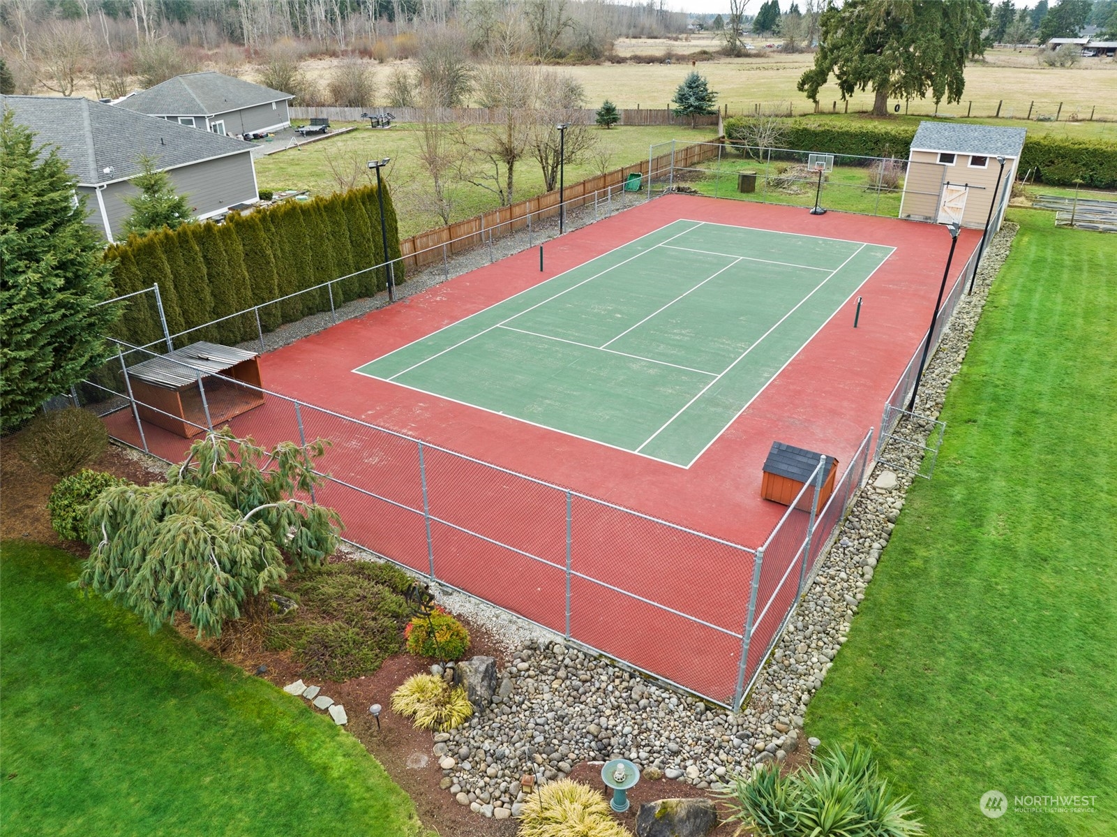 6504 263rd Street East Graham, WA 98338 - Photo 28 of 38 a view of a tennis ground with large trees