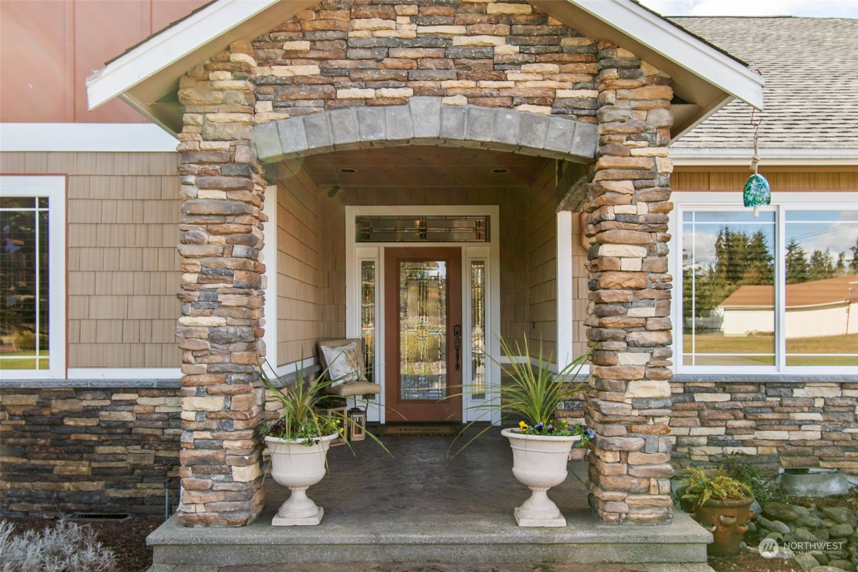 6504 263rd Street East Graham, WA 98338 - Photo 3 of 38 a front view of a house with a potted plant