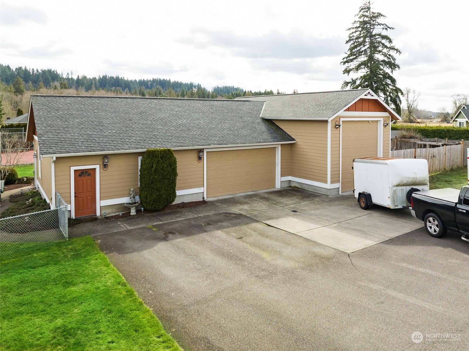 6504 263rd Street East Graham, WA 98338 - Photo 32 of 38 a view of a house with a backyard and a patio