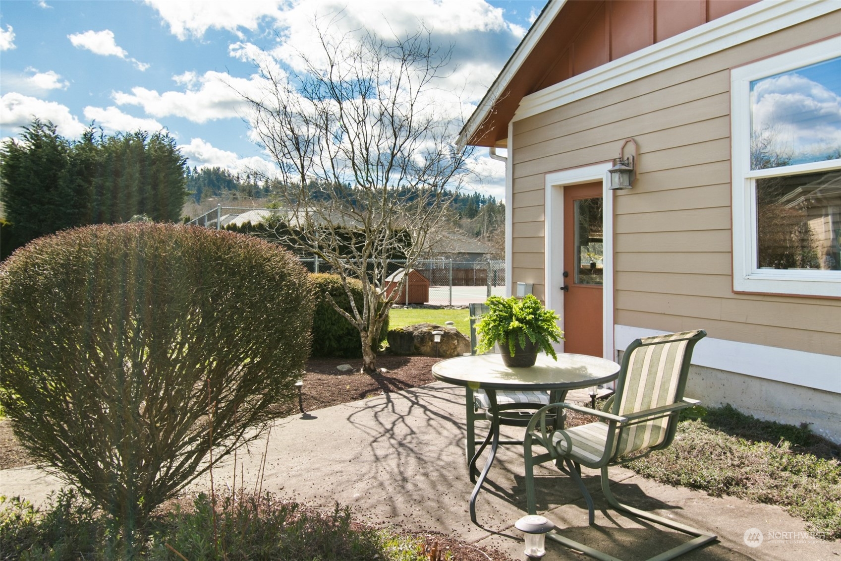 6504 263rd Street East Graham, WA 98338 - Photo 36 of 38 a view of a patio with table and chairs and potted plants