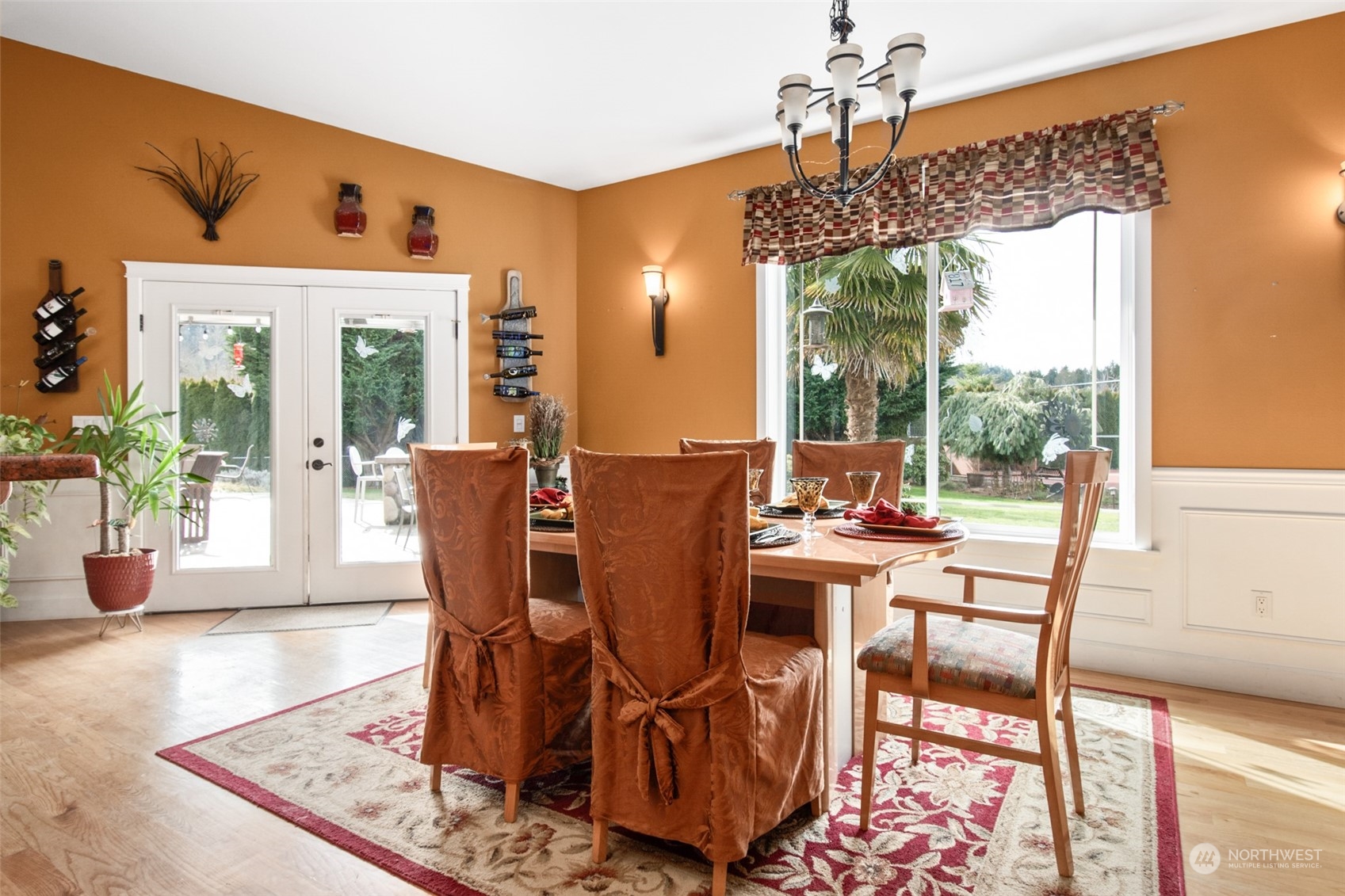 6504 263rd Street East Graham, WA 98338 - Photo 9 of 38 a view of a dining room with furniture wooden floor and a chandelier