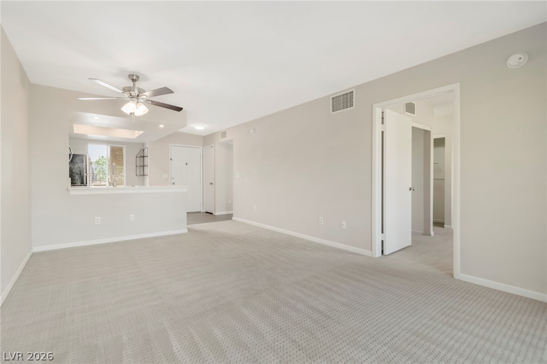 8070 West Russell Road, Unit 2006 Las Vegas, NV 89113 - Photo 13 of 24 A spacious living area with light-toned walls and plush carpeting awaits your personal touch.