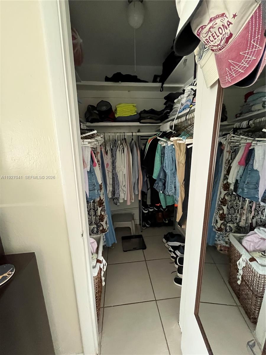 10011 Southwest 162nd Street Miami, FL 33157 - Photo 11 of 18 a view of walk in closet with clothes and shoes