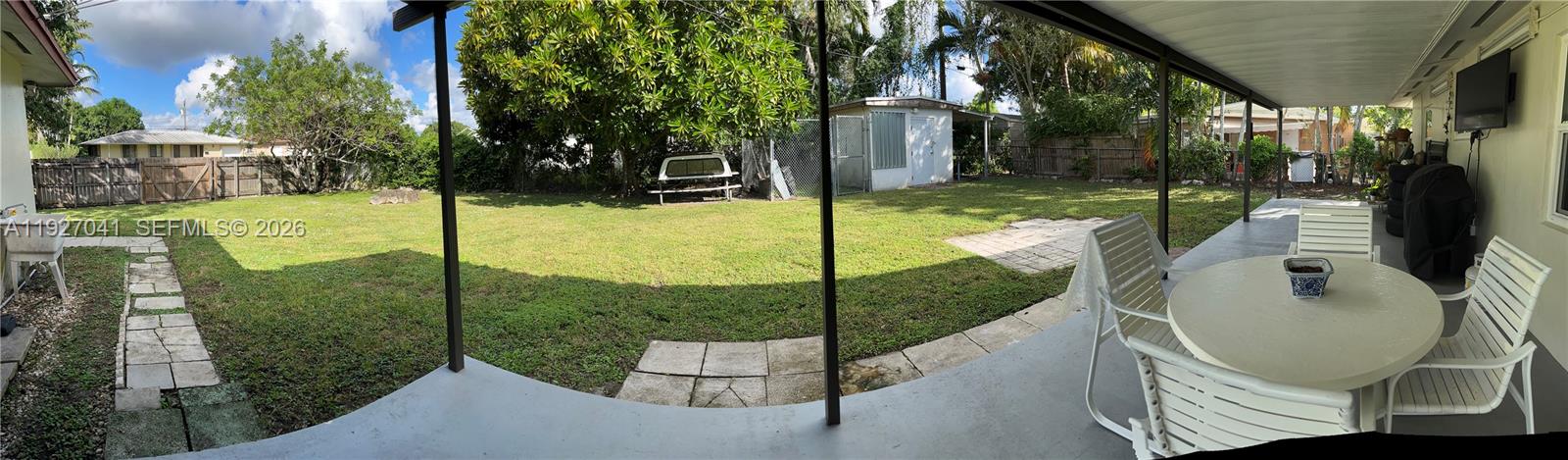 10011 Southwest 162nd Street Miami, FL 33157 - Photo 13 of 18 a view of a chair and table in the patio