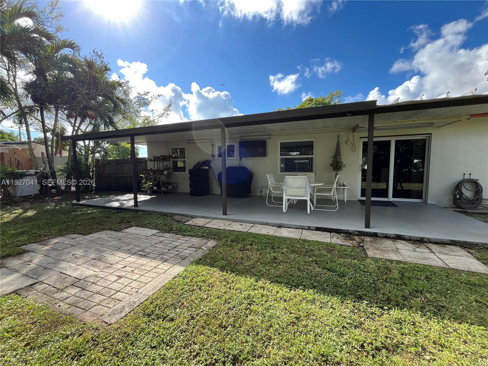 10011 Southwest 162nd Street Miami, FL 33157 - Photo 19 of 22 a view of a house with a yard and a patio