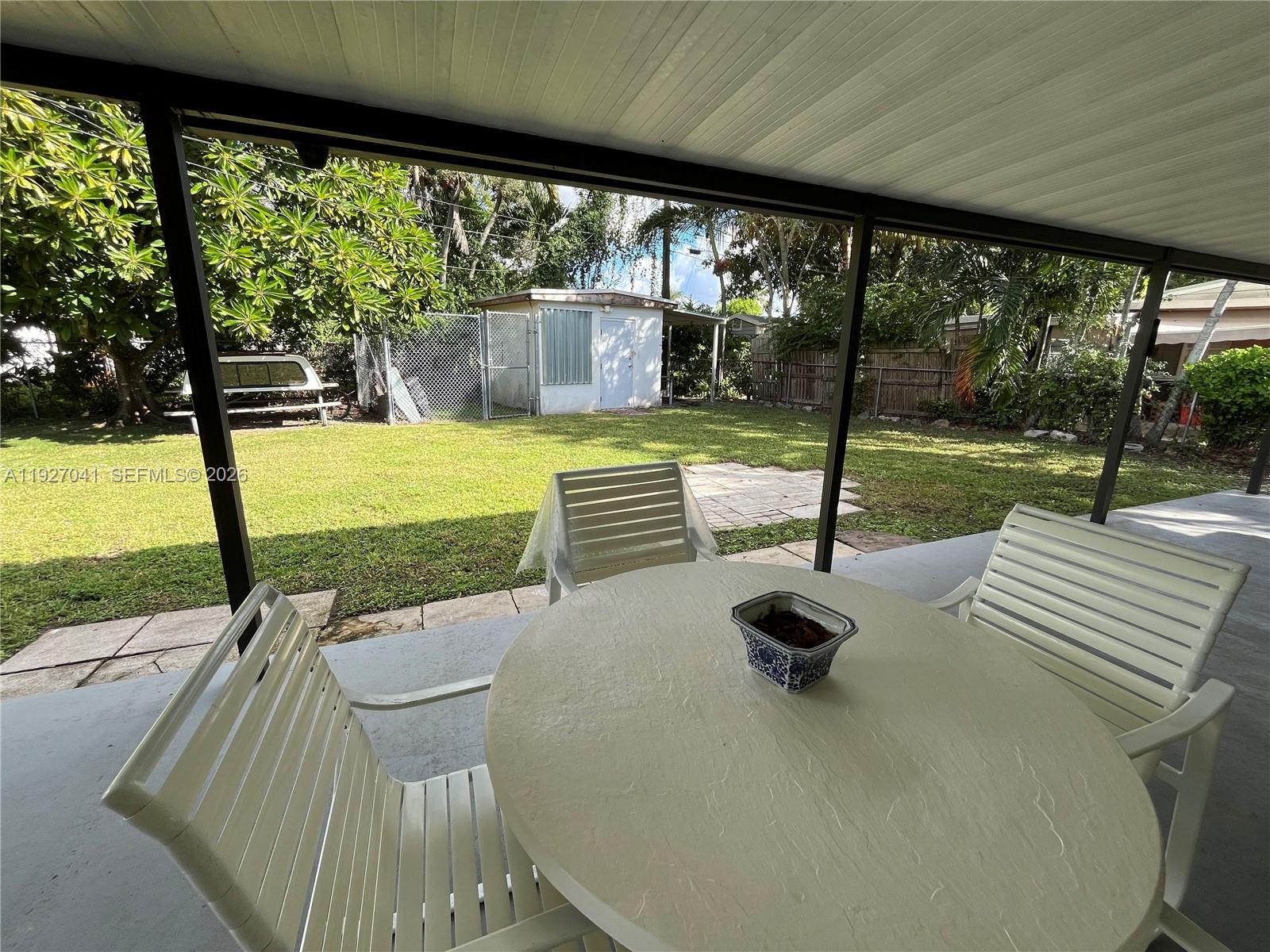 10011 Southwest 162nd Street Miami, FL 33157 - Photo 20 of 22 a view of swimming pool with a table and chairs