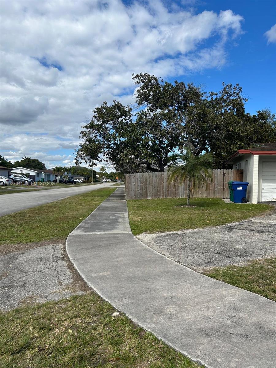 10011 Southwest 162nd Street Miami, FL 33157 - Photo 2 of 22 a view of a garden with a building in the background