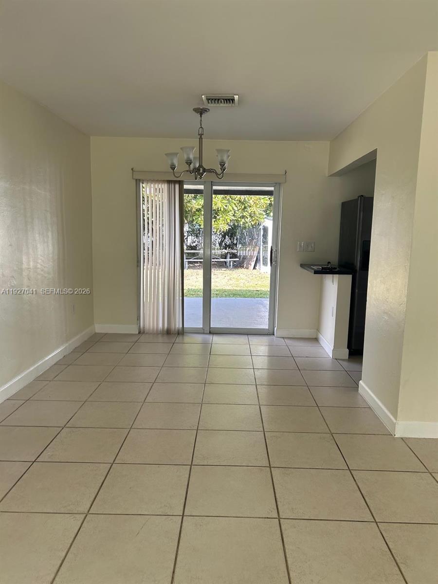 10011 Southwest 162nd Street Miami, FL 33157 - Photo 5 of 22 a view of an empty room with a window