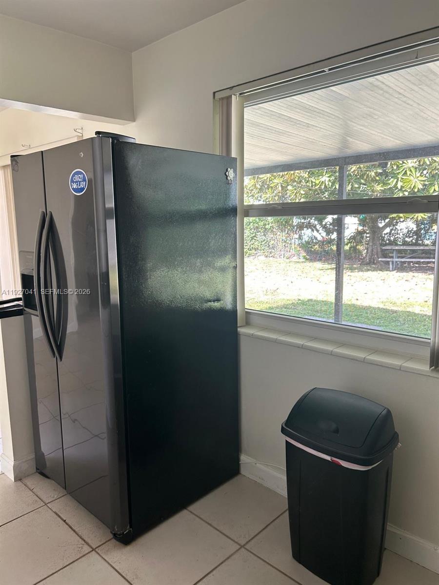 10011 Southwest 162nd Street Miami, FL 33157 - Photo 6 of 22 a kitchen with a refrigerator and a window