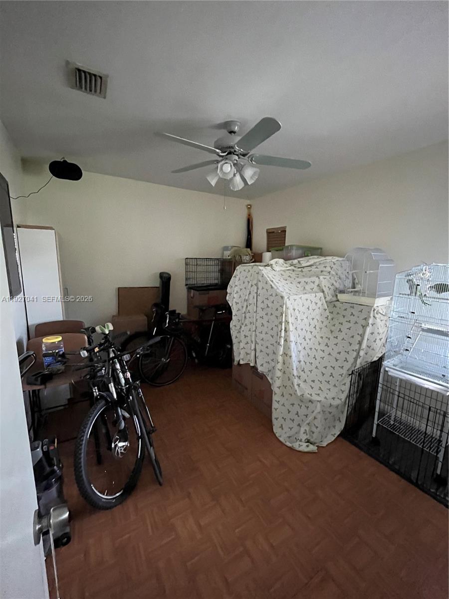 10011 Southwest 162nd Street Miami, FL 33157 - Photo 7 of 18 a bedroom with a bed and a chandelier