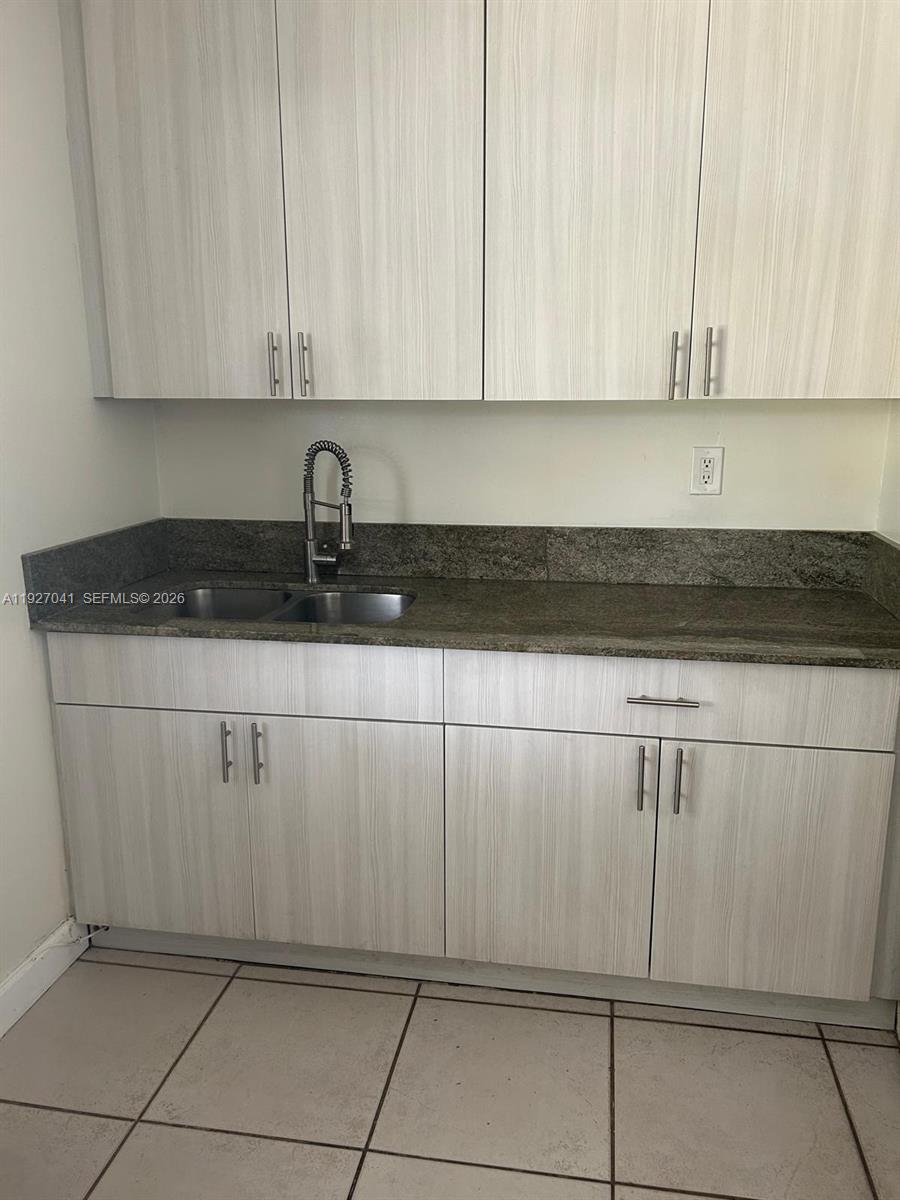 10011 Southwest 162nd Street Miami, FL 33157 - Photo 8 of 22 a kitchen with white cabinets