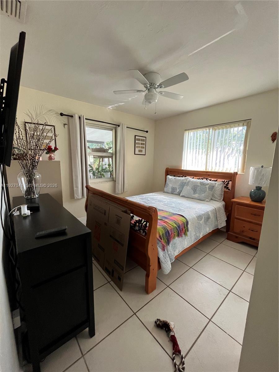 10011 Southwest 162nd Street Miami, FL 33157 - Photo 9 of 18 a bedroom with a bed and a window
