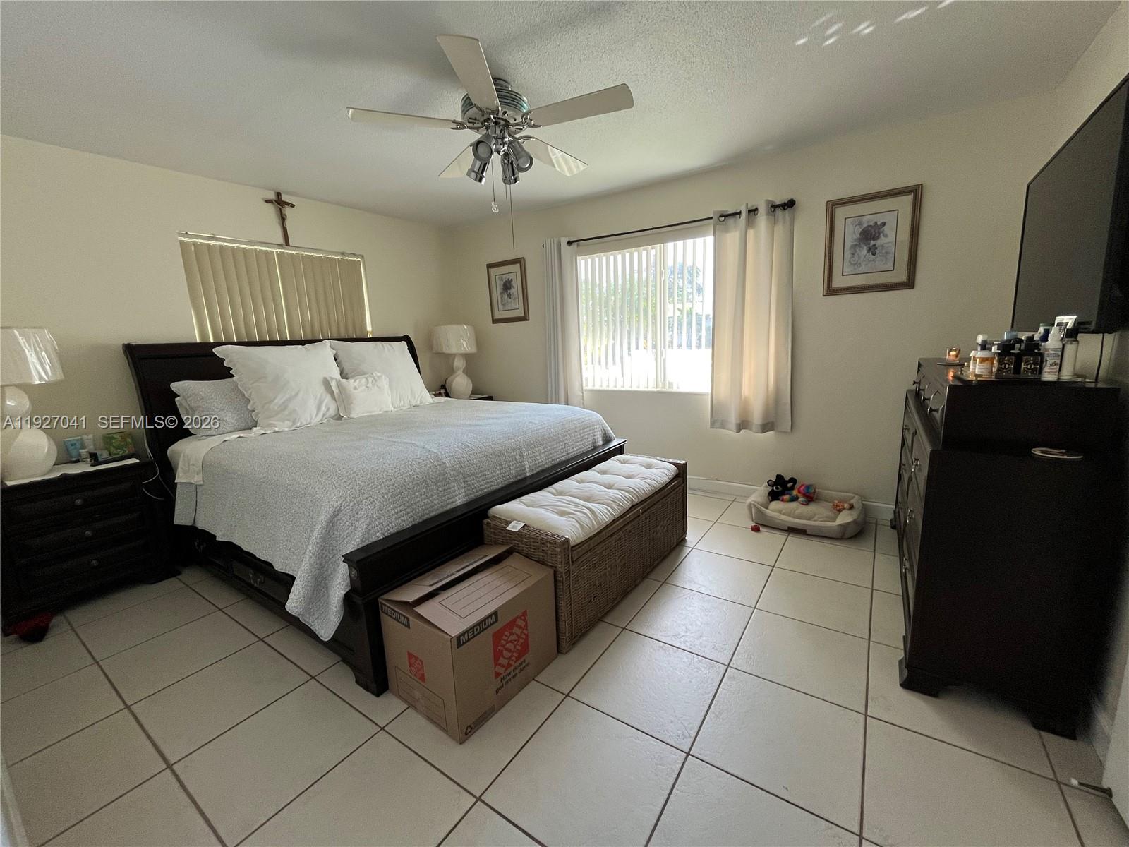 10011 Southwest 162nd Street Miami, FL 33157 - Photo 10 of 18 a bedroom with a bed and a flat screen tv