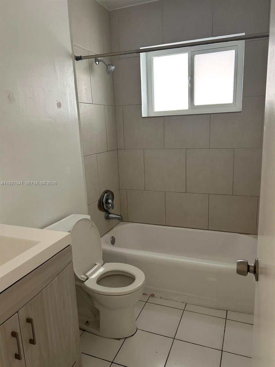 10011 Southwest 162nd Street Miami, FL 33157 - Photo 10 of 22 a bathroom with a toilet a sink and a bathtub