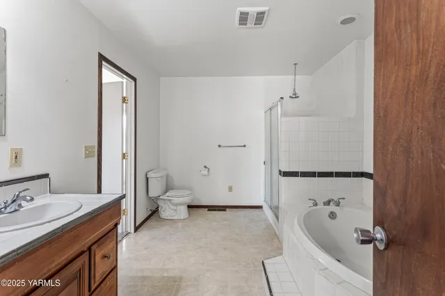 a bathroom with a tub sink and toilet