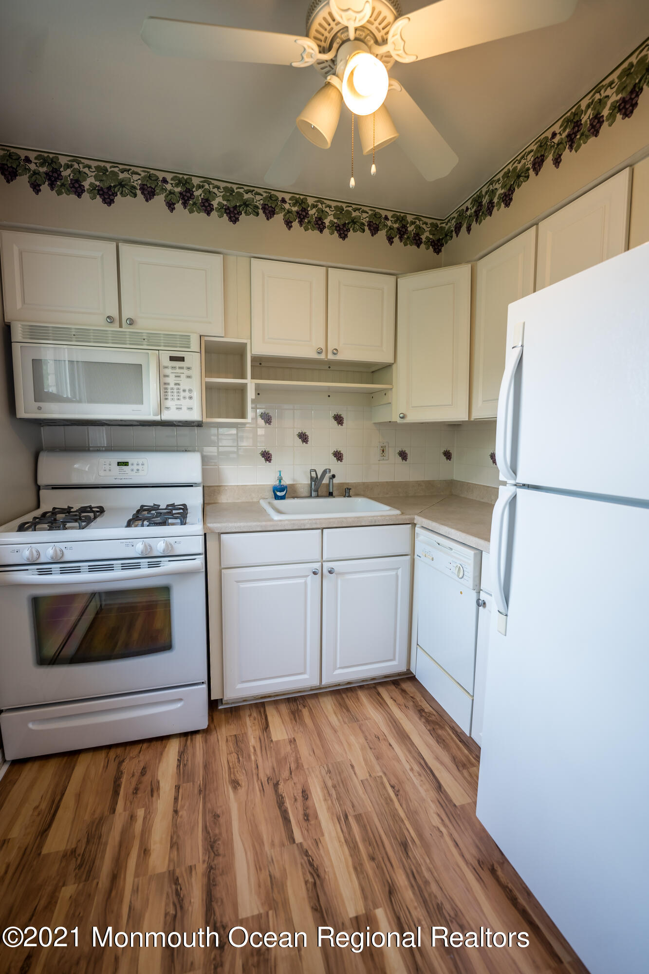420 Cross Road, Unit B2 Matawan, NJ 07747 - Photo 5 of 8 a kitchen with a stove a sink and a refrigerator