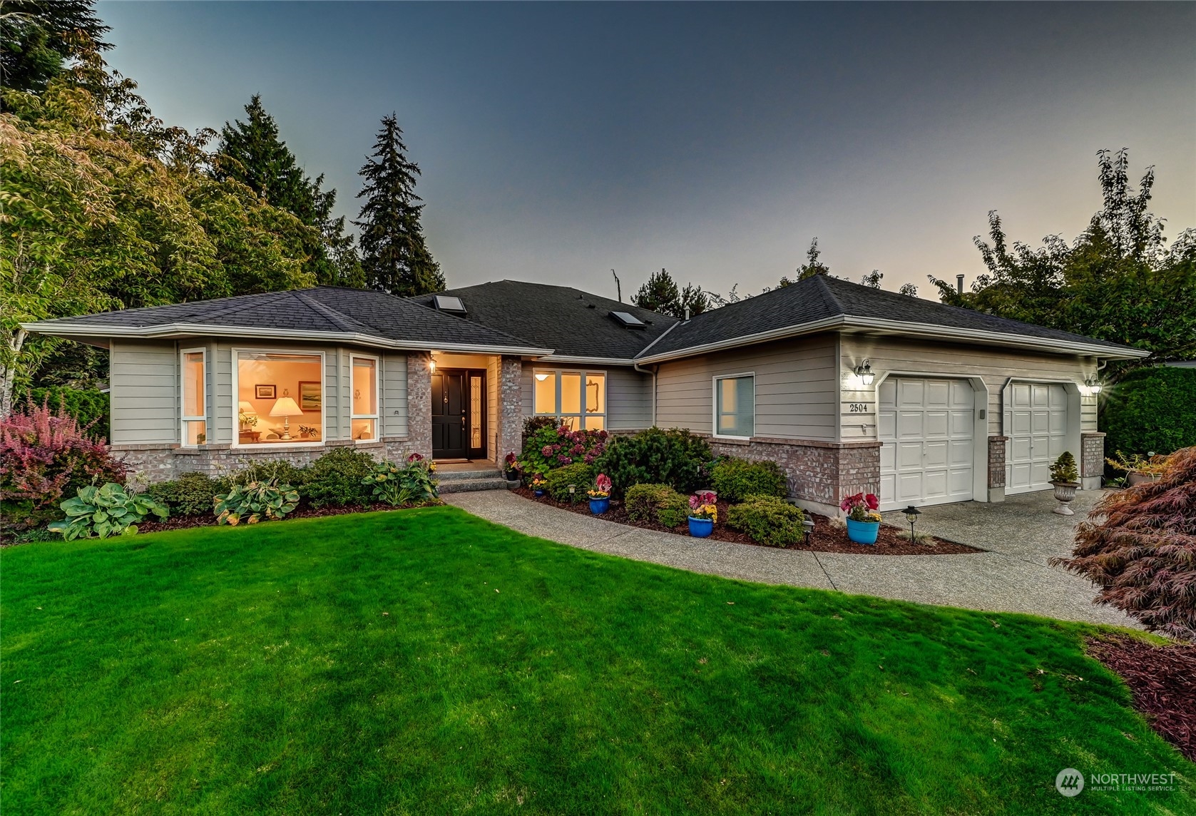 2504 240th Street Southeast Bothell, WA 98021 - Photo 1 of 40 a front view of a house with a garden