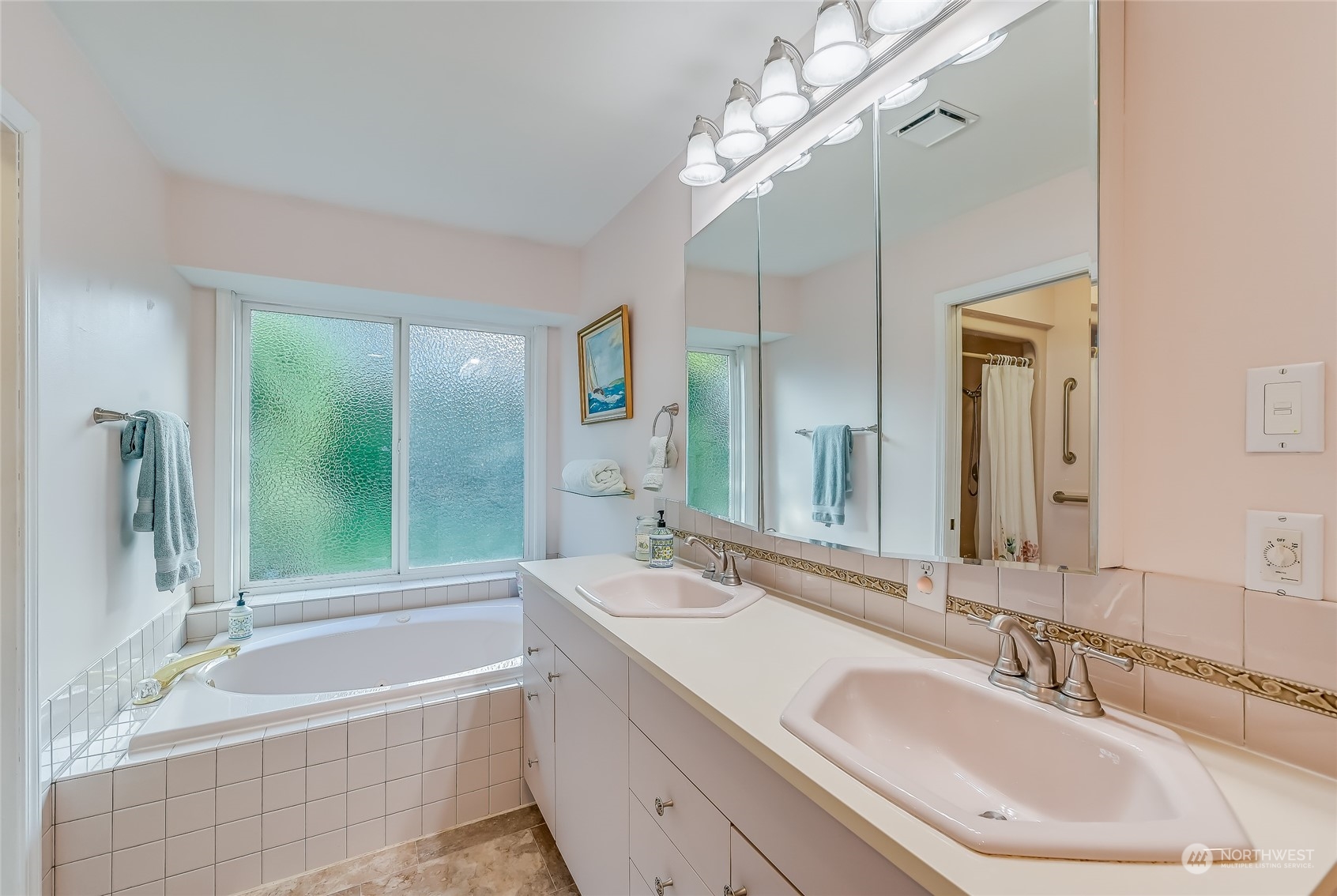 2504 240th Street Southeast Bothell, WA 98021 - Photo 21 of 40 a bathroom with a bathtub a double vanity sink and mirror