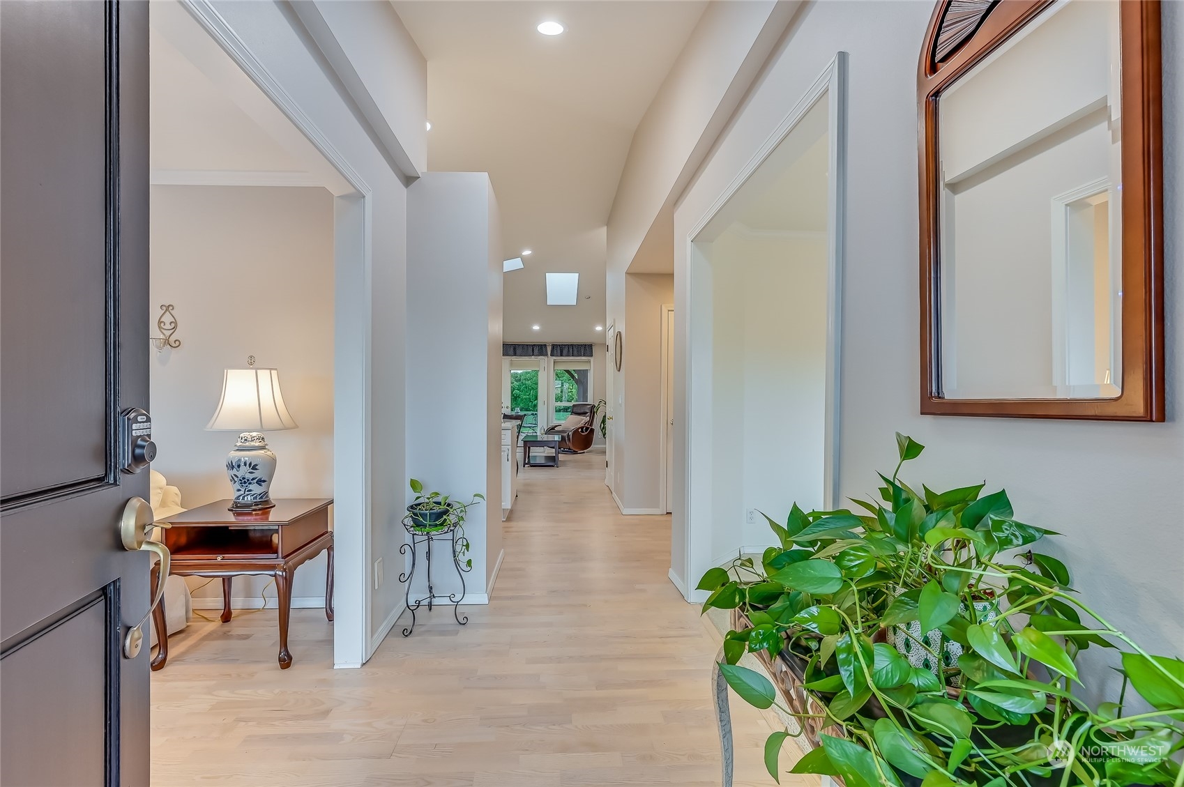 2504 240th Street Southeast Bothell, WA 98021 - Photo 3 of 40 a hallway with wooden floor and a potted plant