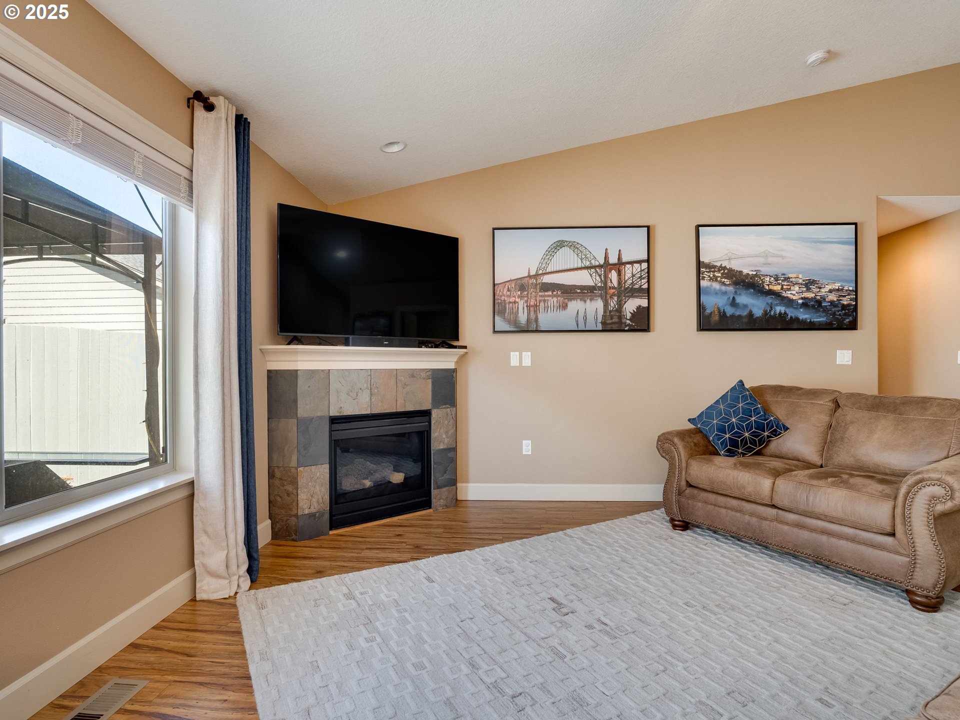 1047 Taurus Loop Northeast Keizer, OR 97303 - Photo 12 of 23 a living room with furniture a flat screen tv and a fireplace