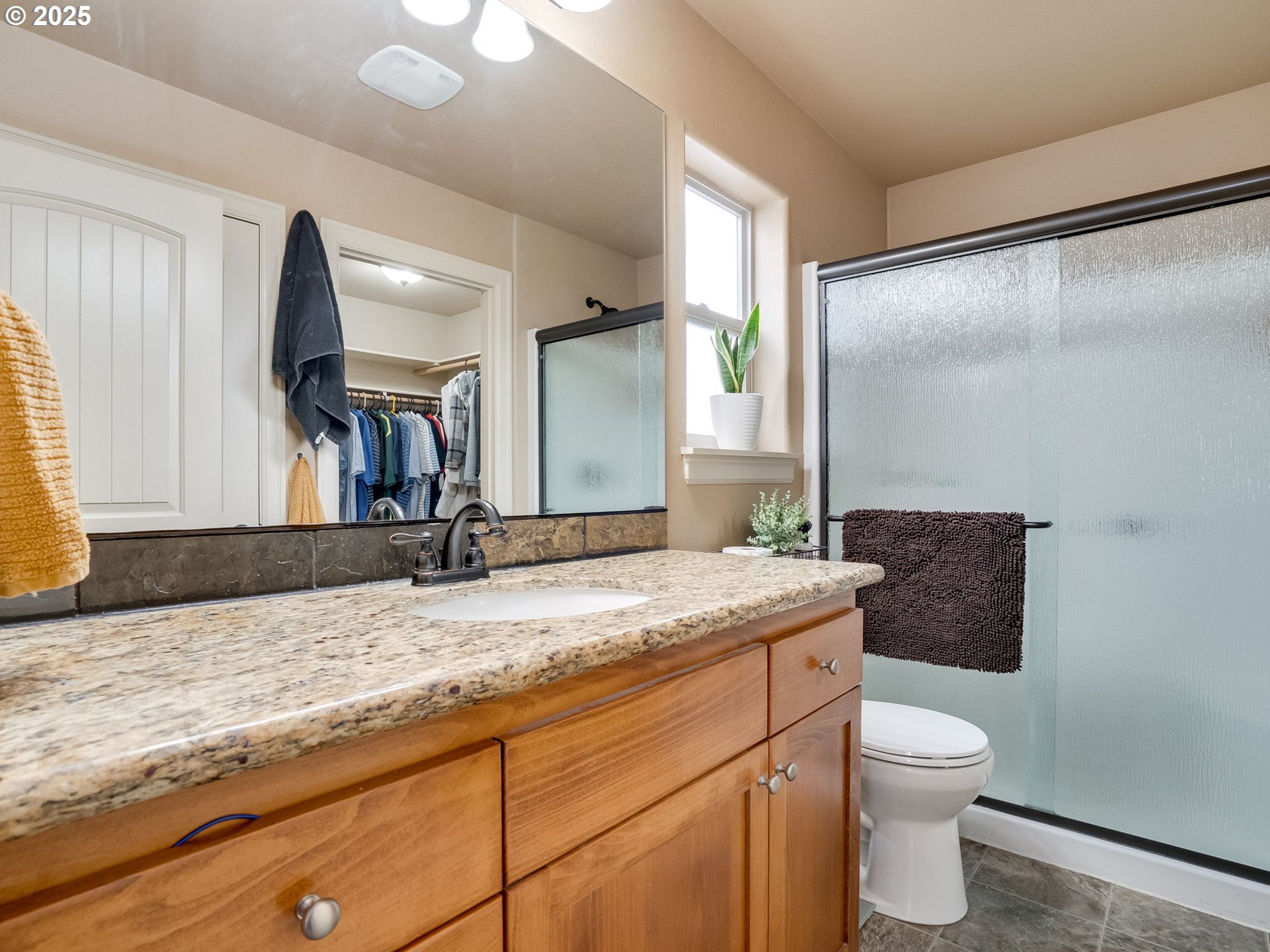 1047 Taurus Loop Northeast Keizer, OR 97303 - Photo 15 of 23 a bathroom with a granite countertop sink mirror vanity and toilet