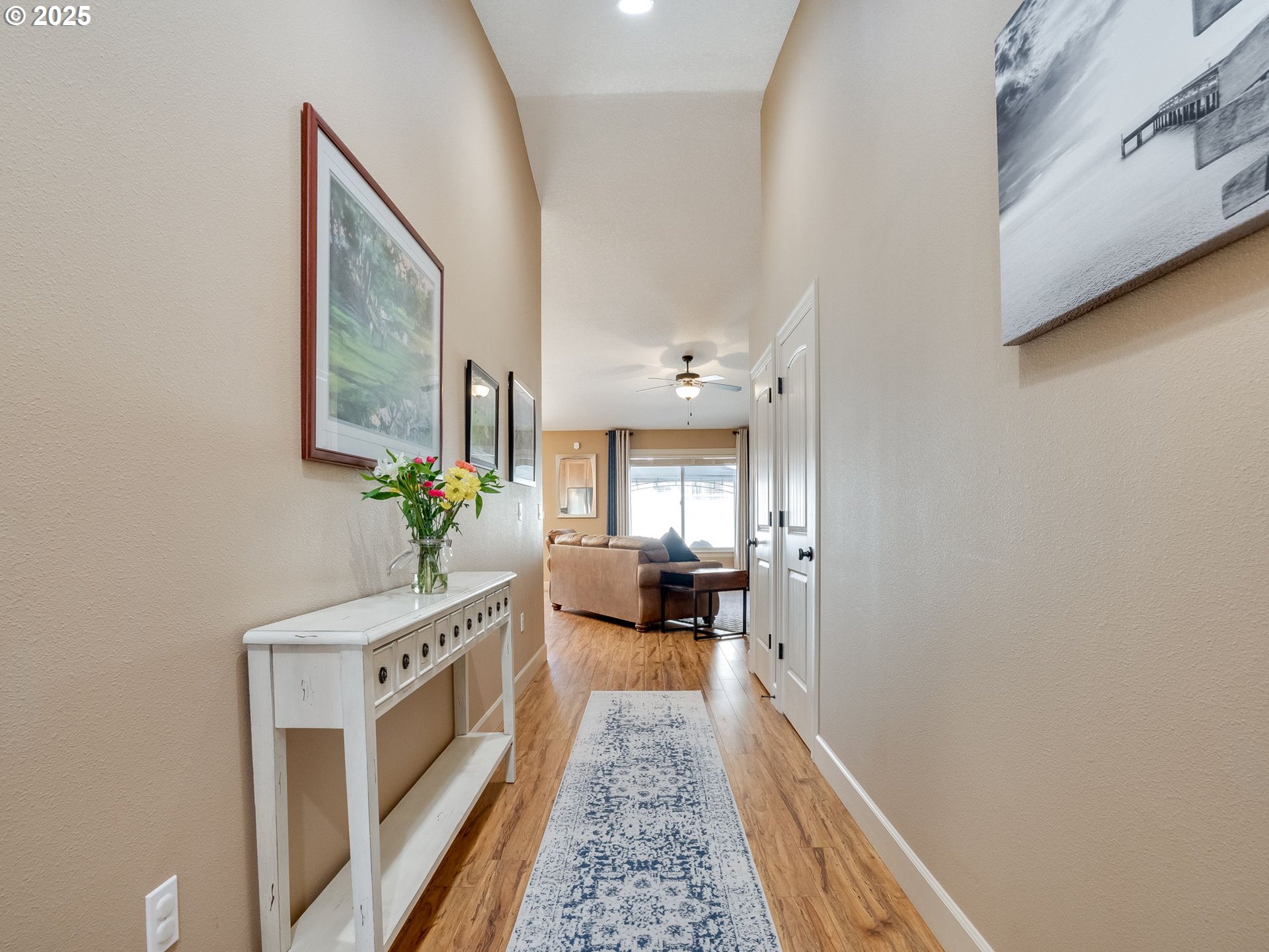 1047 Taurus Loop Northeast Keizer, OR 97303 - Photo 5 of 23 a hallway with a white couches with wooden floor