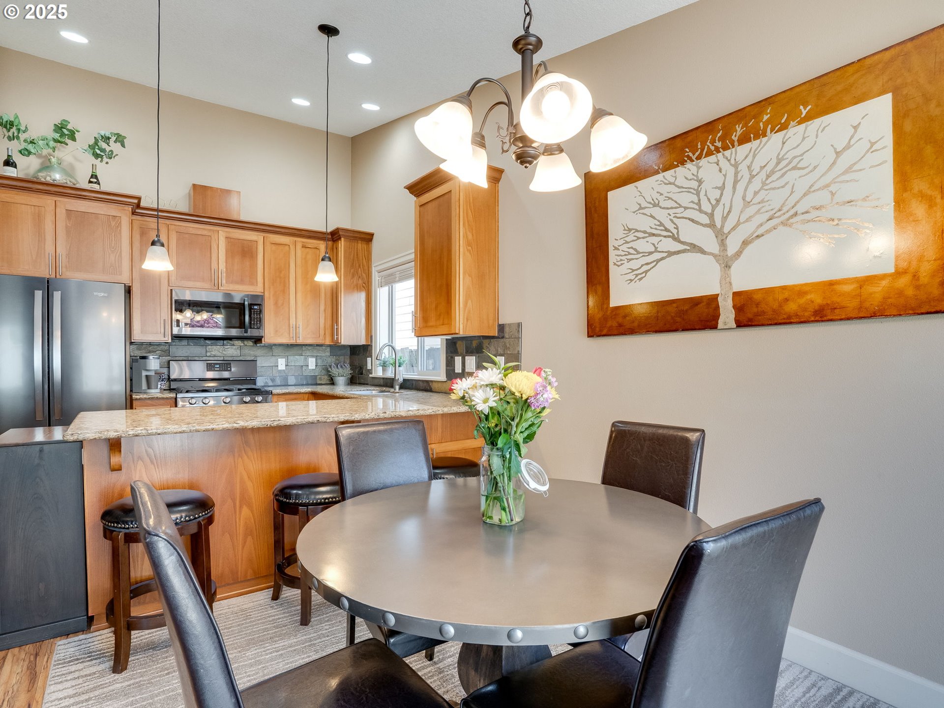 1047 Taurus Loop Northeast Keizer, OR 97303 - Photo 9 of 23 a view of a dining room with furniture a chandelier and wooden floor