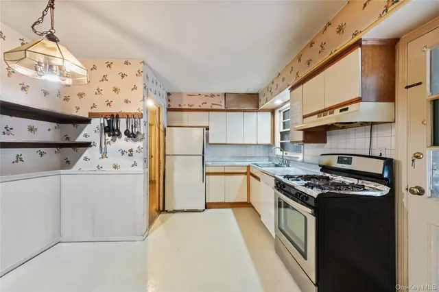 a kitchen with a stove a refrigerator and a stove