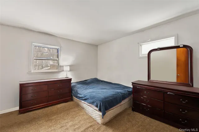a living room with a bed and a dresser