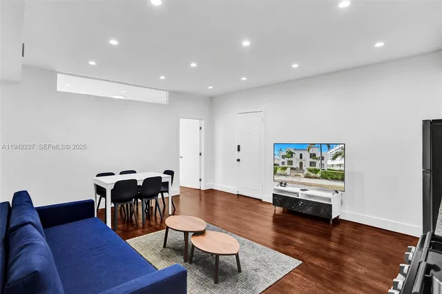 a living room with furniture and wooden floor
