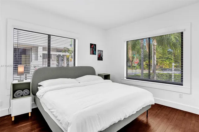 a bedroom with a large bed and a large window