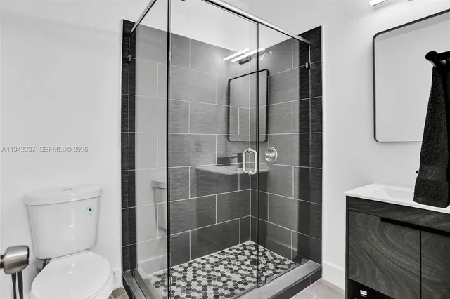 a bathroom with a toilet and a shower